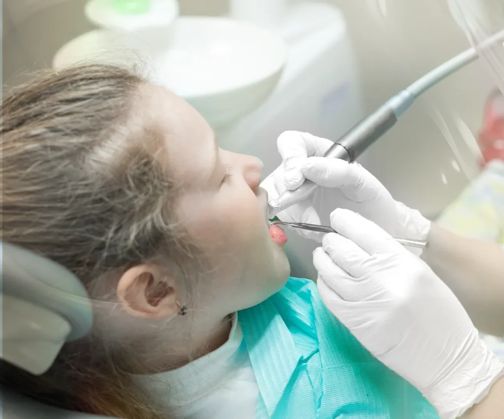 Child receiving professional dental cleaning from a pediatric dentist