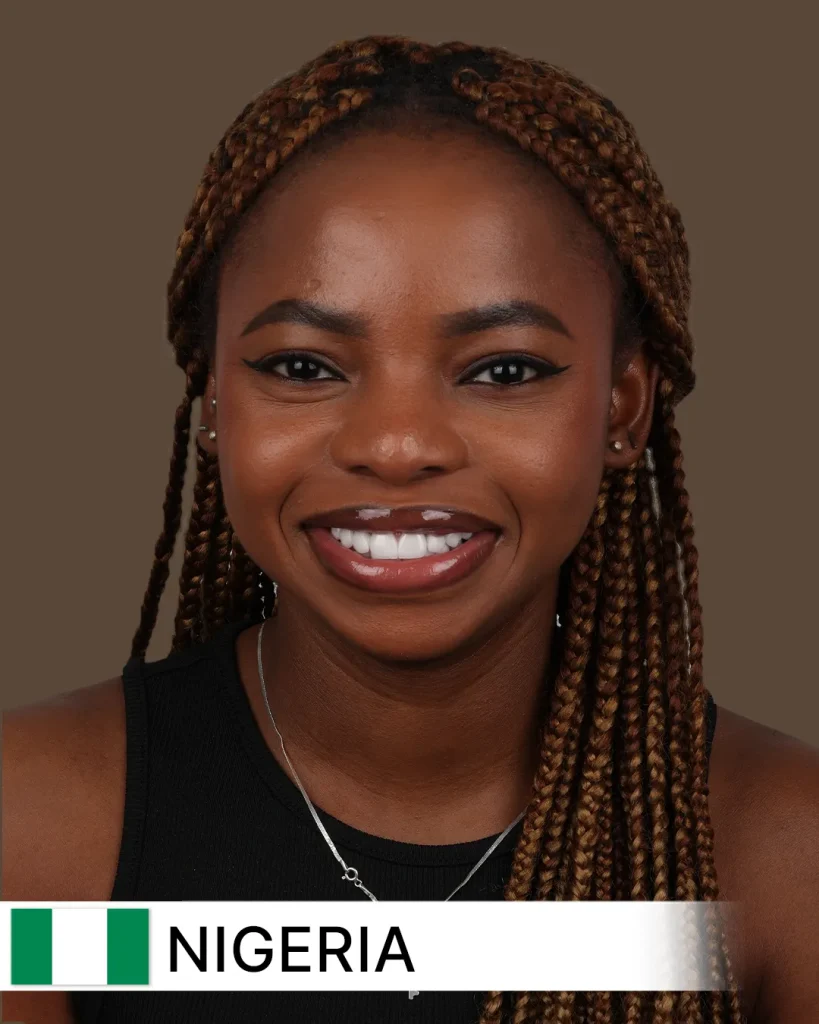 Close-up of a smiling patient, likely an adult from Nigeria, proudly showcasing visibly whiter, straighter, and beautifully aligned teeth after a successful smile makeover. The background is softly blurred, suggesting a modern dental clinic setting.