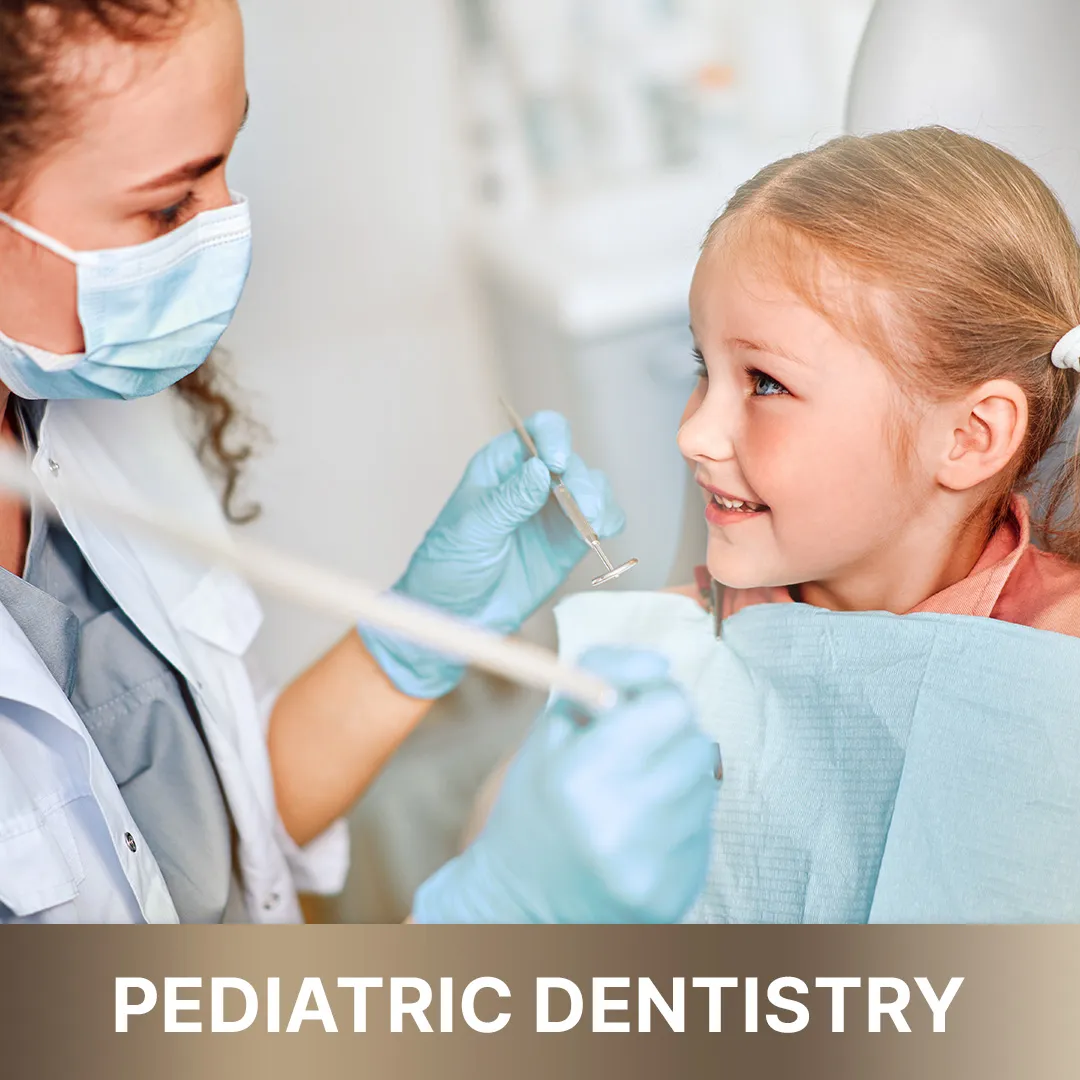 Child smiling comfortably in a dental chair, representing gentle pediatric dentistry from 'Queens Elite' services.